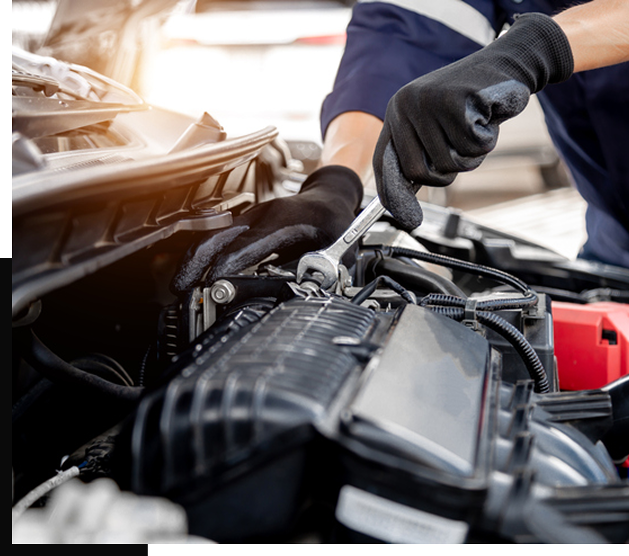 Mechanic working on car engine