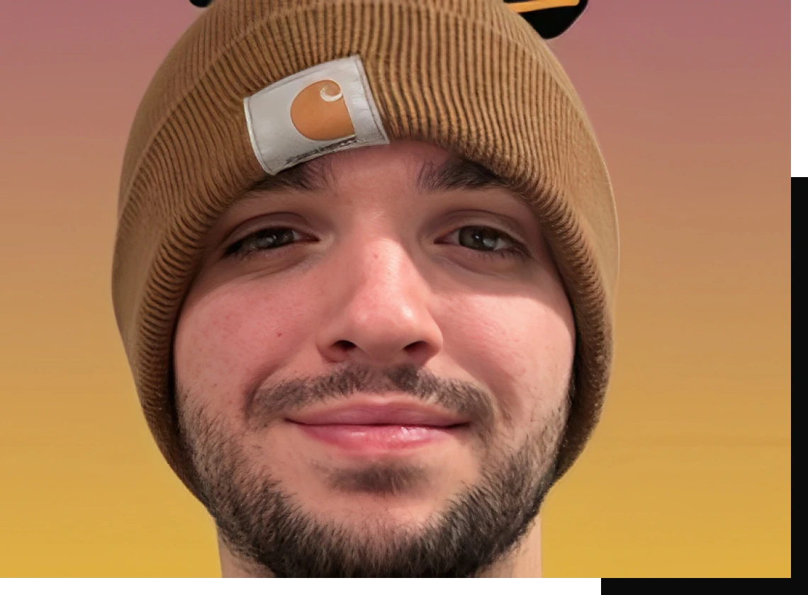 Man wearing a brown beanie, smiling